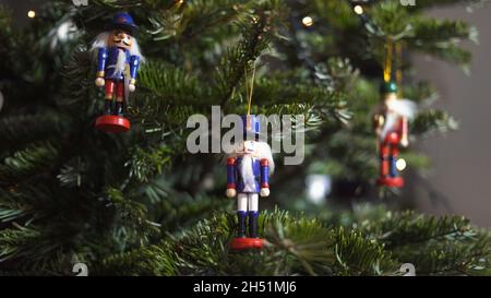 Decoration Toy Nutcracker on Christmas Tree. Nutcracker Soldier on a Christmas Tree With Blurred Background. Beautiful Decorated Christmas Tree, the N Stock Photo
