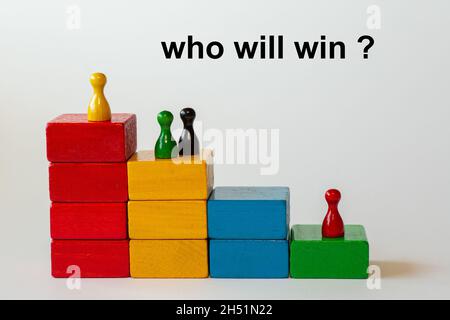 colored wooden blocks form a staircase with wooden figures in different colors. Background isolated in white with the text: who will win? Stock Photo