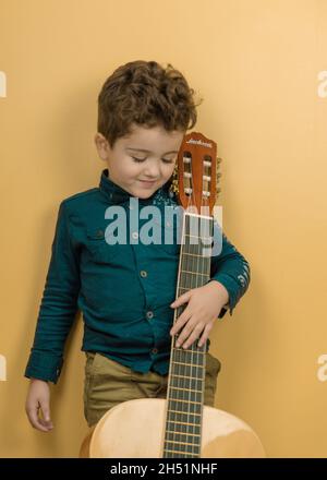 kid plays guitar Stock Photo