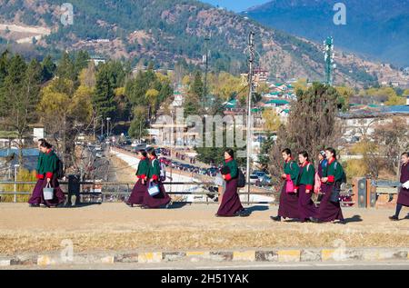 Thimphu, Bhutan - 29 February 2016: Young Bhutanese girls in uniform traditional women dress named kira, wonju (long-sleeved blouse) and a short jacke Stock Photo