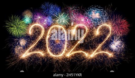 golden bright modern sparkler number 2022 with colorful fireworks isolated on black. happy new year eve celebration background Stock Photo