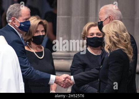 Former United States President George W. Bush, left, shakes hands with US President Joe Biden, top right, as they attend the funeral of former US Secretary of State Colin L. Powell at the Washington National Cathedral in Washington, DC on Friday, November 5, 2021. Looking on are former first lady Laura Bush, second left, former US Secretary of State Hillary Rodham Clinton, center, and first lady Dr. Jill Biden, bottom right. Credit: Ron Sachs/CNP Stock Photo