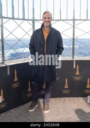 New York, USA. 05th Nov, 2021. Actor Tony Hale attends Empire State Building hosting cast of Clifford the Big Red Dog movie. ESB will be lit in red to celebrate the release of the film in New York on November 5, 2021. Chief Programs Officer, Best Friends Animal Society Marc Peralta, actor Tony Hale, actress Darby Camp, actor Jack Whitehall, actor Izaac Wang, and SVP Scholastic Entertainment & Executive Producer of the movie Caitlin Friedman pose with dog Asher on observation deck. (Photo by Lev Radin/Sipa USA) Credit: Sipa USA/Alamy Live News Stock Photo