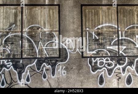 Bangkok, Thailand - Dec 12, 2019 : Wood vintage window on the old wall and graffiti painting. Stock Photo