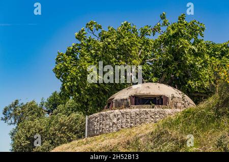 Closeup of one of the countless military concrete bunkers or pillboxes in southern Albania built by communist government of Enver Hoxha. Bunker is tur Stock Photo