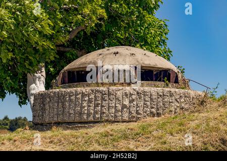 Closeup of one of the countless military concrete bunkers or pillboxes in southern Albania built by communist government of Enver Hoxha. Bunker is tur Stock Photo