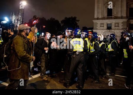 London, UK. 05th Nov, 2021. Protesters clash with the Police outside the Parliament. Protesters gathered at Trafalgar square for the annual Million Mask March. The annual demonstration was first called by the hactivist group Anonymous on the Guys Fawkes Day in 2012. Credit: SOPA Images Limited/Alamy Live News Stock Photo