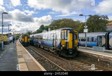 1325 departure Class 156 and 1323 Class 156 Scotrail DMU at Barrhead Railway Station in Barrhead Scotland UK with 1327  Class 156 right for Glasgow Stock Photo