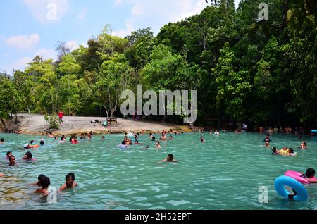 Gate entrance and wooden label in Emerald Pool or Sa Morakot turquoise blue pond at Thung Teao Forest Natural Park for thai people and foreign travele Stock Photo