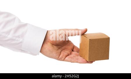 Man holds in hand a cardboard box isolated on white background, template for designers Stock Photo