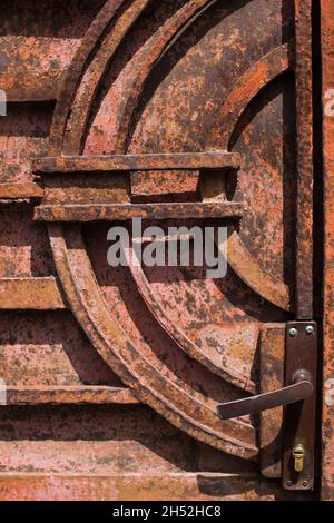Rusty iron door with handle and lock. Stock Photo