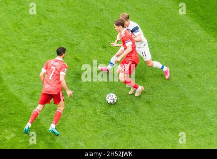 Saint Petersburg, Russia – June 16, 2021. Russia players Alexey Miranchuk and Magomed Ozdoyev against Finland striker Rasmus Schuller during EURO 2020 Stock Photo