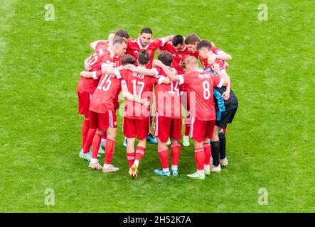 Saint Petersburg, Russia – June 16, 2021. Russia national football team players huddling before the second half of EURO 2020 match Finland vs Russia ( Stock Photo