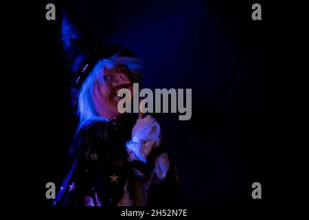 Witch toy on dark background for Halloween decoration Stock Photo