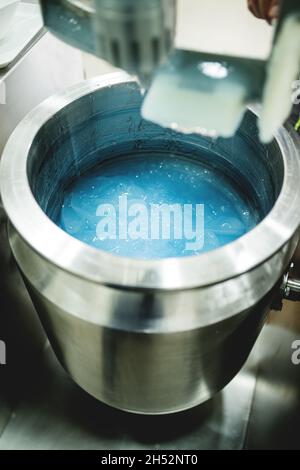 Mixer full of blue gel. Silicon product, medicine, health care industry. Stock Photo