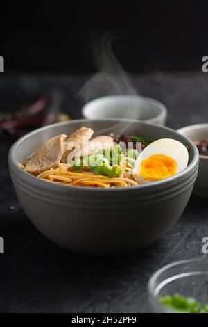 Ramen is asian noodles in a bowl with vegetables or seafood, often flavored with soy sauce or miso, with toppings such as sliced pork, nori, menma. Da Stock Photo