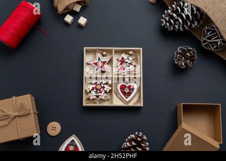 Unpacking Christmas decorations. Christmas composition with small wooden decorations for the Christmas tree. Top view, flat lay Stock Photo