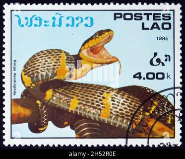 LAOS - CIRCA 1986: a stamp printed in Laos shows mangrove snake, boiga dendrophila, is a species of mildly venomous snake endemic to southeast Asia, c Stock Photo