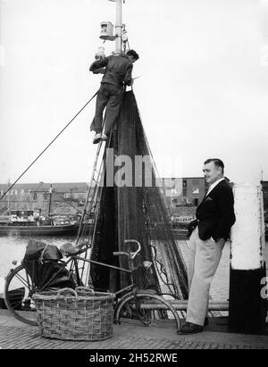 CLARK GABLE on set location candid in Delft Holland during filming of BETRAYED 1954 director GOTTFRIED REINHARDT cinematographer Freddie Young Metro Goldwyn Mayer Stock Photo
