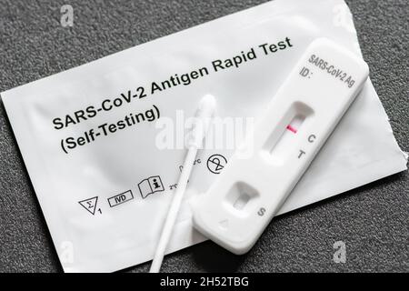 Negative Covid-19 antigen test kit, one step coronavirus antigen rapid test, saliva swab, 1 test box with imagine of lungs, close up Stock Photo