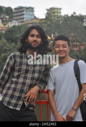 Two young guys posing for photo in outside with looking at camera Stock Photo