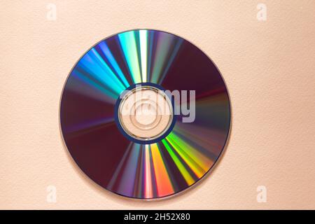 cd or dvd drive reflecting light, pink background Stock Photo