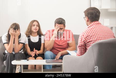 parents with kid talk to social worker. mom dad and daughter. life insurance and adoption Stock Photo