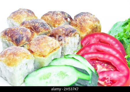 Turkish pastry with tomato and cucumber as a snack, Turkish borek, isolated on white background Stock Photo