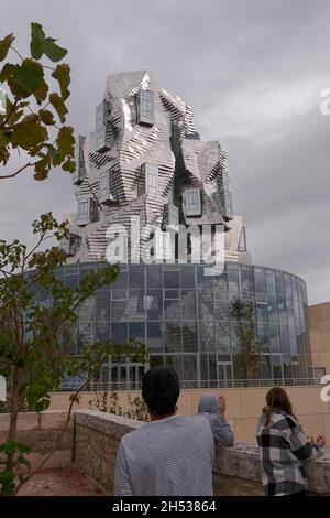 Luma Gallery by architect Frank Gehry reflected in the pool on the Parc des Ateliers Arles ...