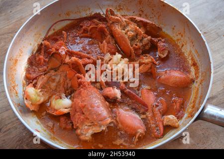 lobster sauce with tomato puree in aluminum pan to season pasta Stock Photo
