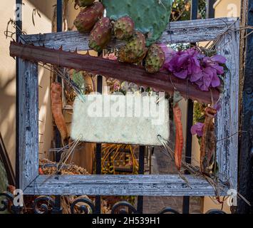 empty advertising bord in a blue wooden frame of flowers and a cactus, Greece, Oktober 11, 2021 Stock Photo