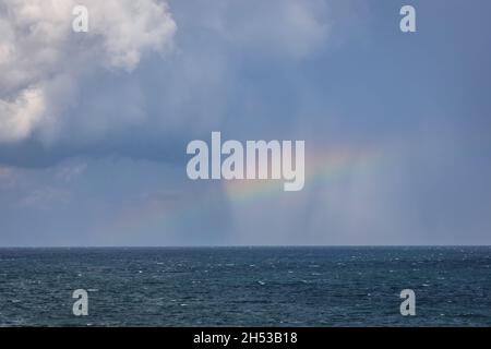 Rainbow over Black Sea seen from shore in Tyulenovo village and seaside resort, part of Shabla Municipality, Dobrich Province in Bulgaria Stock Photo