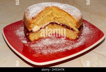 HOME BAKED SPONGE CAKE WITH FRESH CREAM LAYER AND STRAWBERRY JAM Stock Photo
