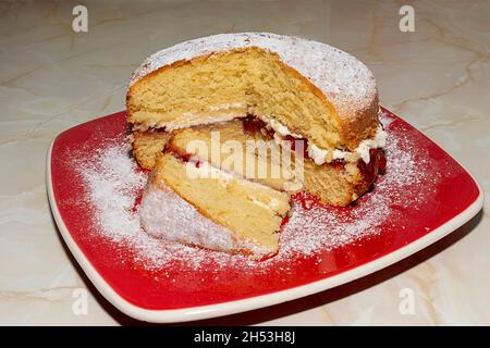 HOME MADE SPONGE CAKE WITH FRESH CREAM AND STRAWBERRY JAM Stock Photo
