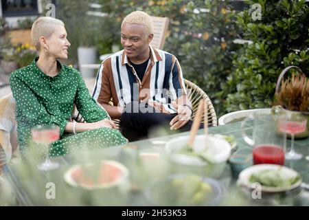 Multiracial couple having dinner at their backyard Stock Photo
