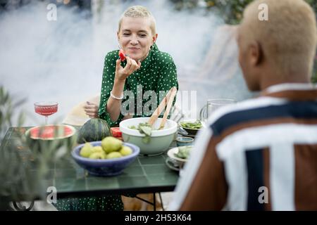 Multiracial couple having dinner at their backyard Stock Photo