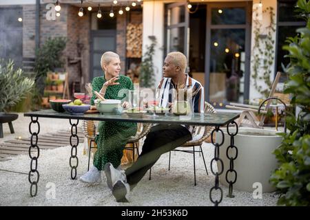 Multiracial couple having dinner at their backyard Stock Photo