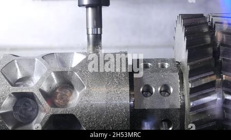 Metalworking cutting process by milling cutter. Media. CNC machine processes metal detail. Close-up of the metal workpiece processing on the latest ma Stock Photo