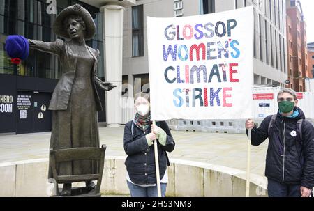 Protesters at the Manchester Trade Union & Workers Bloc beside the statue of suffragette Emmeline Pankhurst in St Peter's Square, Manchester, on the COP26 Global Day of Action Demonstration for Climate Justice, city centre Manchester, England, United Kingdom, on 6th November, 2021.
