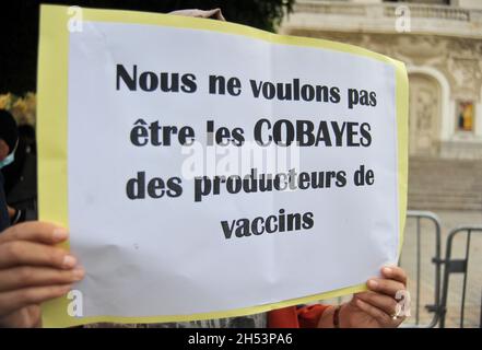 November 6, 2021: Tunis, Tunisia. 06 November 2021. A few dozen people hold a protest against compulsory vaccinations and Covid passes in front of the Municipal Theatre in the Tunisian capital. Demonstrators raised slogans against Covid-19 vaccines and the obligation of the vaccine pass, questioning their safety and expressing fears of possible side-effects. Tunisian authorities have recently announced that a proof of full vaccination is required to attend both public and private gatherings, with a Covid-19 vaccine pass also becoming mandatory to enter public as well as private spaces such as Stock Photo