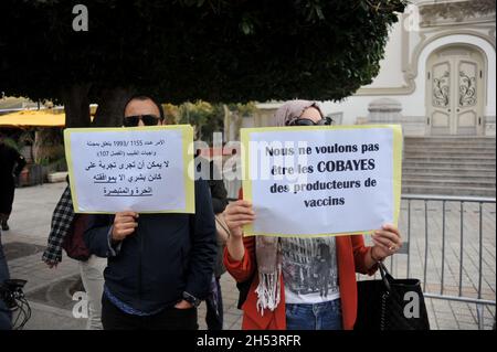 November 6, 2021: Tunis, Tunisia. 06 November 2021. A few dozen people hold a protest against compulsory vaccinations and Covid passes in front of the Municipal Theatre in the Tunisian capital. Demonstrators raised slogans against Covid-19 vaccines and the obligation of the vaccine pass, questioning their safety and expressing fears of possible side-effects. Tunisian authorities have recently announced that a proof of full vaccination is required to attend both public and private gatherings, with a Covid-19 vaccine pass also becoming mandatory to enter public as well as private spaces such as Stock Photo