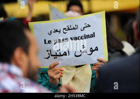 November 6, 2021: Tunis, Tunisia. 06 November 2021. A few dozen people hold a protest against compulsory vaccinations and Covid passes in front of the Municipal Theatre in the Tunisian capital. Demonstrators raised slogans against Covid-19 vaccines and the obligation of the vaccine pass, questioning their safety and expressing fears of possible side-effects. Tunisian authorities have recently announced that a proof of full vaccination is required to attend both public and private gatherings, with a Covid-19 vaccine pass also becoming mandatory to enter public as well as private spaces such as Stock Photo