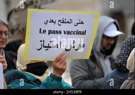 November 6, 2021: Tunis, Tunisia. 06 November 2021. A few dozen people hold a protest against compulsory vaccinations and Covid passes in front of the Municipal Theatre in the Tunisian capital. Demonstrators raised slogans against Covid-19 vaccines and the obligation of the vaccine pass, questioning their safety and expressing fears of possible side-effects. Tunisian authorities have recently announced that a proof of full vaccination is required to attend both public and private gatherings, with a Covid-19 vaccine pass also becoming mandatory to enter public as well as private spaces such as Stock Photo