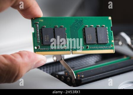 Upgrading the personal computer concept. Closeup the new memory module or random access memory (RAM). The DDR4 memory module with 260 pins. Stock Photo