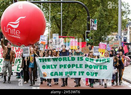 Bristol, UK, 6th November, 2021. Protesters carrying climate change banners and placards are pictured as they take part in a climate change protest march through the centre of Bristol. The protest was one of hundreds held around the world today as people took to the streets to push world leaders to act as their negotiators meet in Glasgow at the COP 2021 United Nations Climate Change Conference. Credit: Lynchpics/Alamy Live News Stock Photo