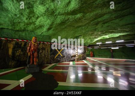 Stockholm, Sweden - 25 June 2016: Sculpture on the Kungstradgarden metro station, carved out of the rock. Green walls. Stock Photo