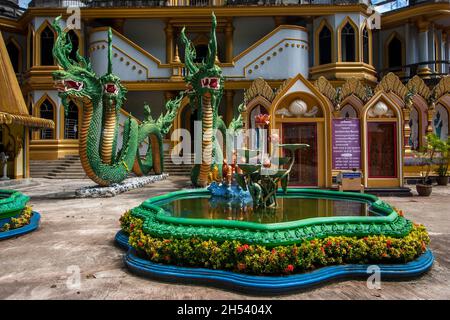 Chinese dragons at the entrance to the Buddhist temple Tiger Cave in Krabi province, Thailand. A pond with clay lotuses. Stock Photo