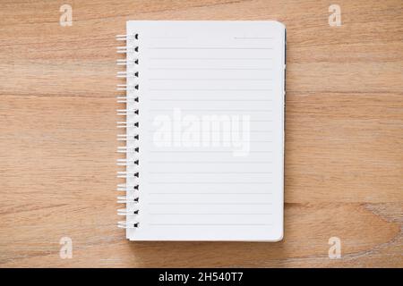 Blank spiral bound notebook journal open on a desk. Flat lay design for journaling, school or message concept Stock Photo