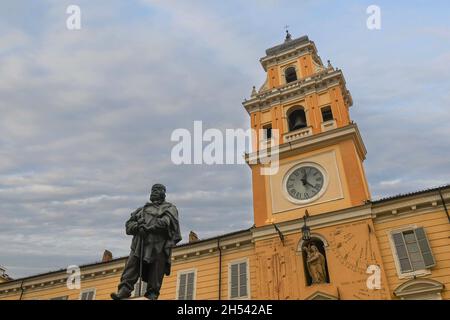 Low-angle view of the Governor's Palace with the civic tower and the statue of Giuseppe Garibaldi in the foreground, Parma, Emilia-Romagna, Italy Stock Photo