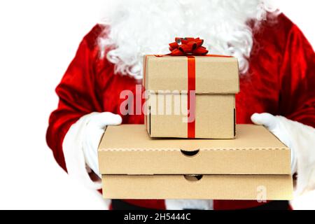 Pizza boxes and a gift in the hands of Santa Claus.  Christmas fast food delivery.  New year's eve promotion. Isolated on white. Stock Photo